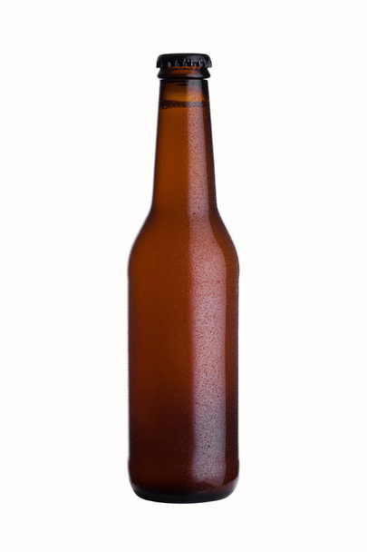 Brown glass beer bottle with black cap with dew - Foto, immagini