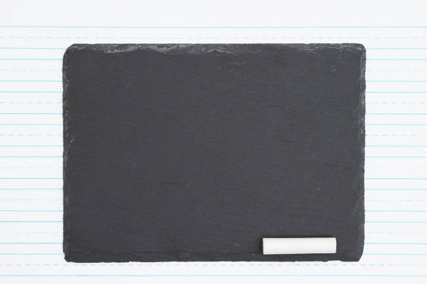 Retro lined paper with weathered old chalkboard and piece of cha - Photo, Image