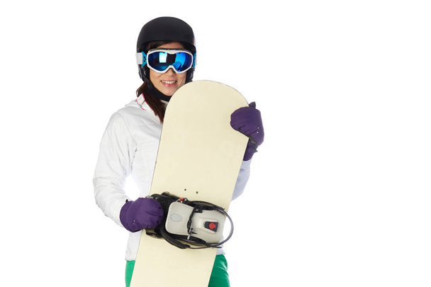 young female snowboarder shot in studio background - Foto, afbeelding