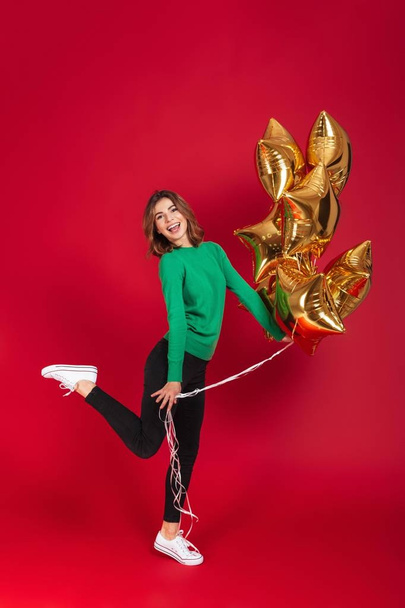 Cheerful young pretty woman holding balloons. - Fotoğraf, Görsel