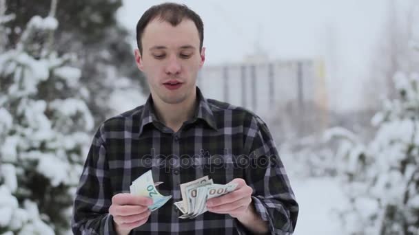young guy holding money - Materiał filmowy, wideo