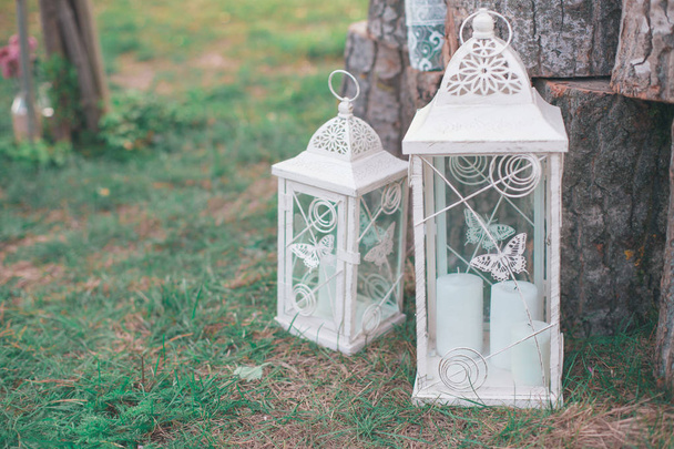 Rustic wedding photo zone. Hand made wedding decorations includes Photo Booth, wooden barrels and boxes, lanterns, suitcases and white flowers - Photo, Image