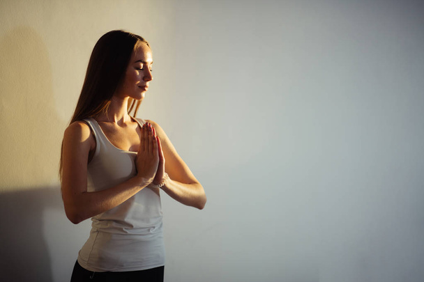 woman practicing yoga and meditation, holding palms together in namaste mudra - Fotografie, Obrázek