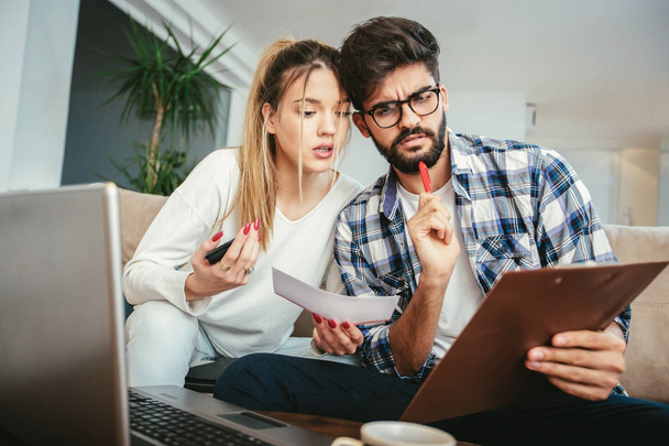 Mujer y hombre haciendo papeleo juntos, pagando impuestos en línea en la PC portátil - Foto, imagen
