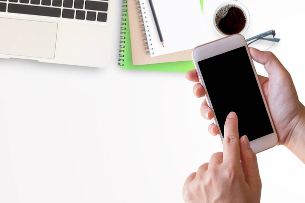 Chytrý telefon v ženské ruce s kancelářský stůl s notebookem - Fotografie, Obrázek