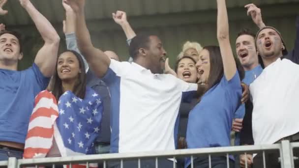 4K Excited fans with US flag in sports crowd, celebrating and cheering on team - Footage, Video