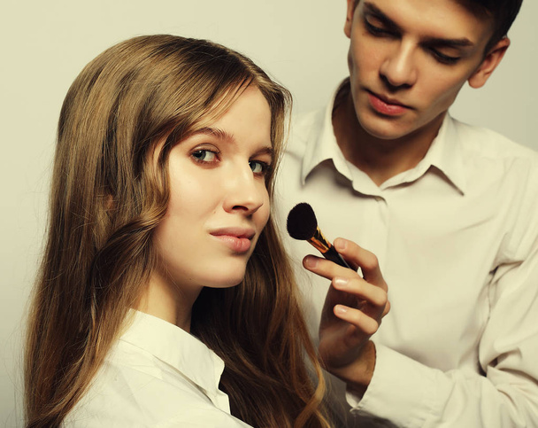 The makeup artist does makeup for young model - Foto, Imagen