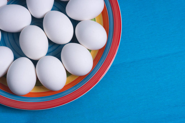 Easter eggs on colorful plate and blue background - Photo, Image