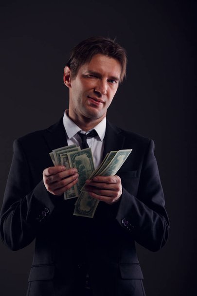 Photo of banker in suit counting dollars - Foto, Imagen