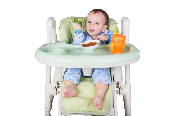 Child is eating sitting at table - Foto, Bild