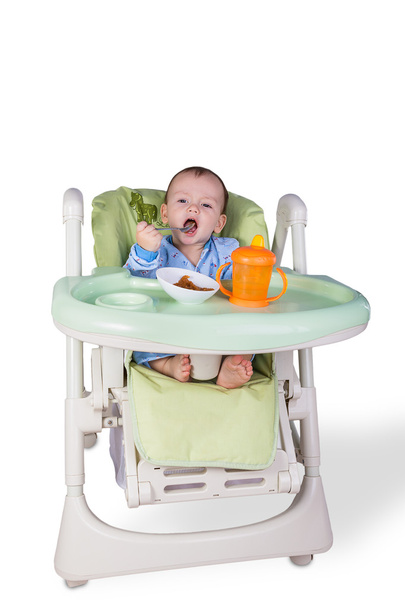 Child is eating sitting at table - Фото, зображення