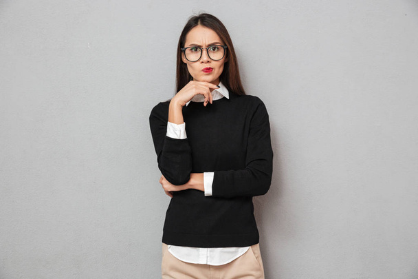 Serious pensive asian woman in business clothes and eyeglasses - Foto, imagen