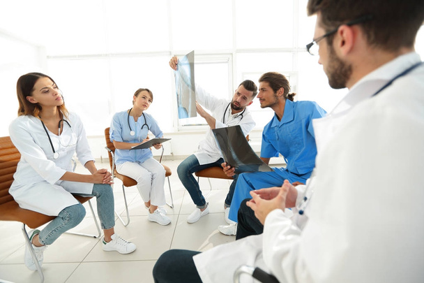 radiologists and a surgeon discussing a radiograph of a patient - Foto, Bild