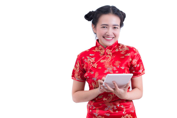 Çince elbise geleneksel cheongsam veya qipao giyen güzel genç Asyalı kadın. Ellerini tutarak ve dizüstü bilgisayar kullanarak. Online alışveriş. Konsept dijital online satın alma. Tablet, sosyal medya dokunmadan el. - Fotoğraf, Görsel