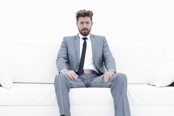 Successful businessman sitting in a suit smokes - Фото, зображення