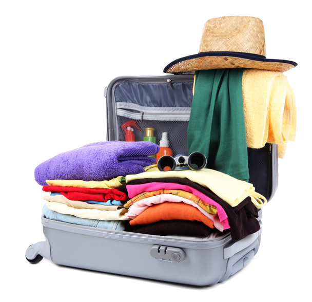 Open silver suitcase with clothing isolated on white - Foto, Bild