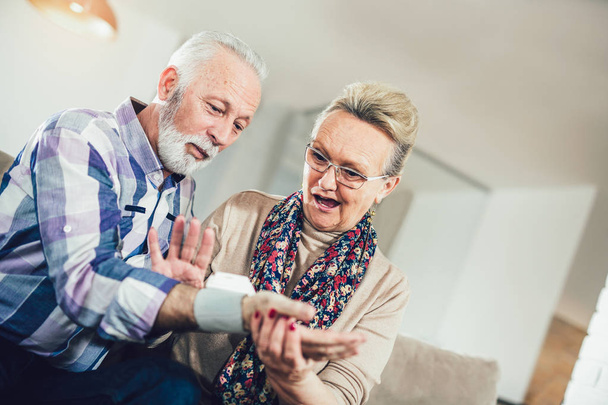 Seniors couple at home measuring blood pressure. Home monitoring - Фото, зображення