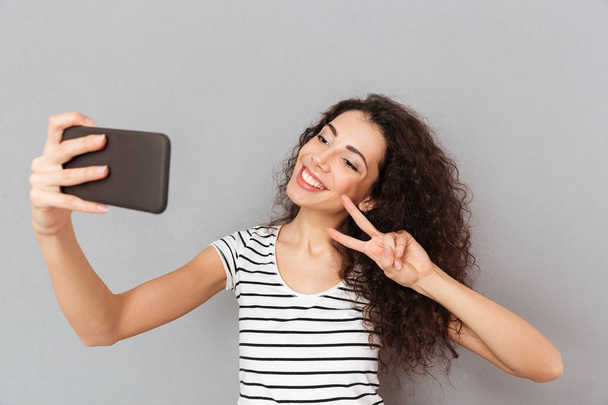 Amazing woman with caucasian appearance making selfie on her sma - Photo, Image