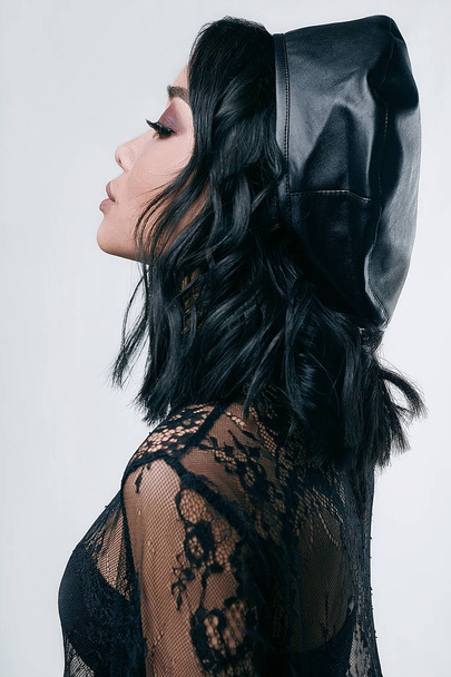 Beautiful charming asian girl in black long dress and leather hat - Фото, зображення