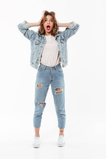 Full length image of Shocked woman in denim clothes - Foto, afbeelding
