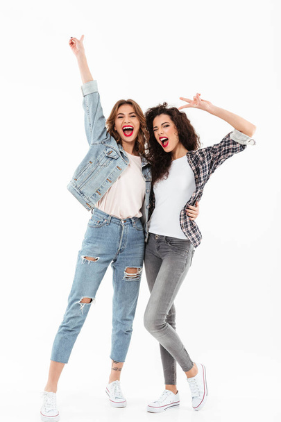 Full length image of two joyful girls standing together - Foto, Imagem