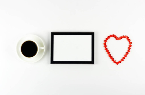 Abstract with cup of coffee, frame and red hearts symbol on white background. Flat lay. Top view. Copy space. - Photo, image