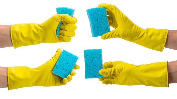 In een gele handschoen voor het reinigen van de hand. Een set van handgebaren houden - Foto, afbeelding