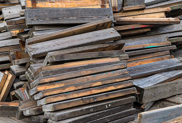 Stack of reclining old brown gray boards repair restoration building background - Photo, Image