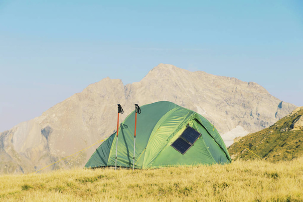 Tent standing on a mountain top. - Фото, зображення