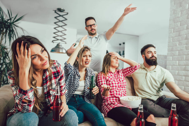 Group of friends watching TV match and cheering - Photo, Image
