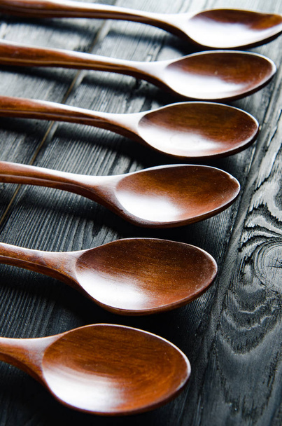 Wooden spoons arranged on table - Fotó, kép