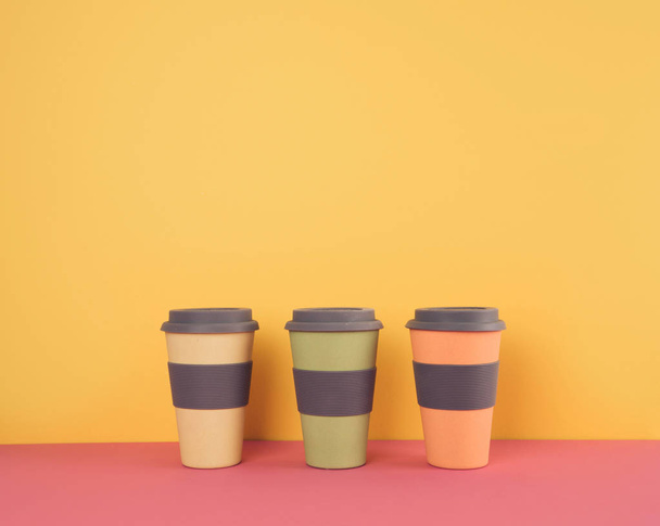 Take away coffee cups on colorful paper background. - Φωτογραφία, εικόνα