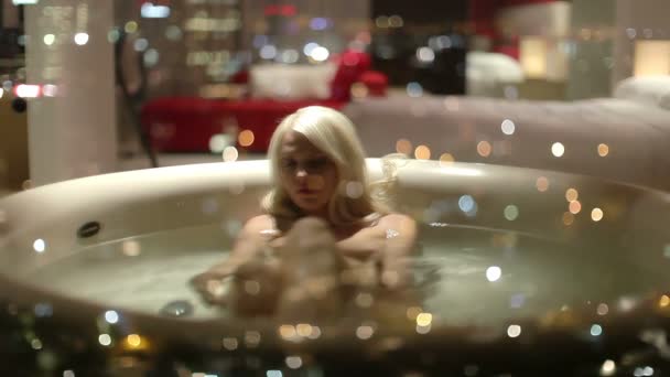 広いホテルのお風呂でセクシーな美しい女性はバラの花びらでいっぱい - 映像、動画
