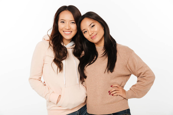Two asian pretty cheerful ladies sisters - Фото, изображение