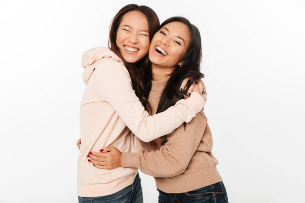 Two asian pretty cheerful ladies sisters - Foto, afbeelding