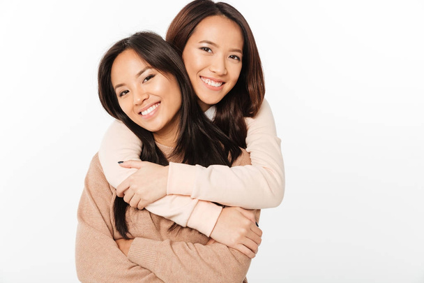 Two asian pretty cheerful ladies sisters - Фото, зображення
