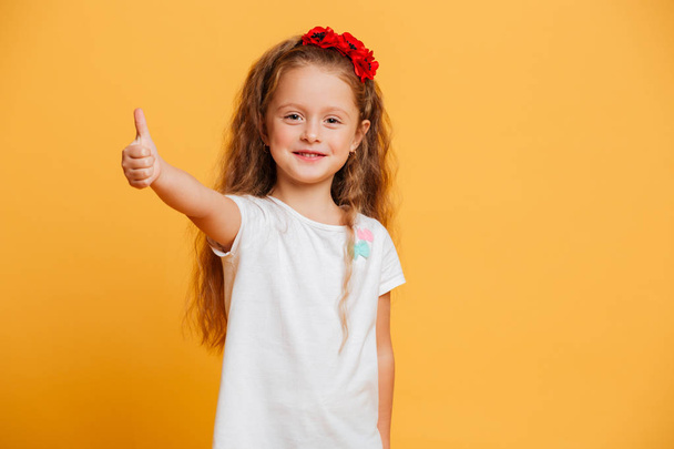 Little girl child standing isolated showing thumbs up. - Φωτογραφία, εικόνα