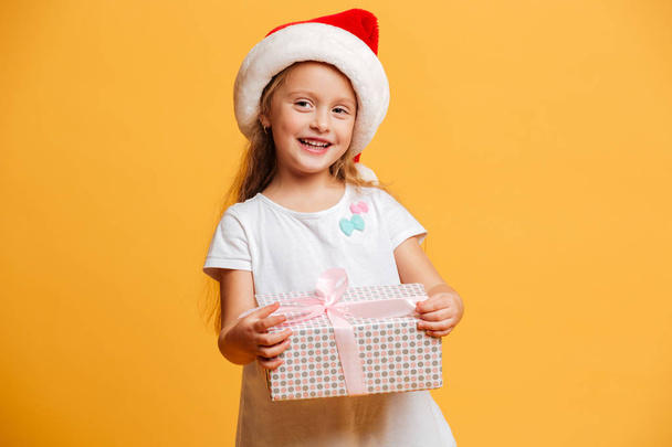 Cheerful girl wearing christmas santa hat - Fotó, kép