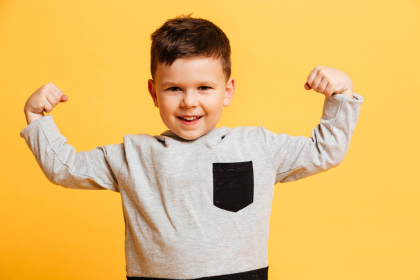 Little boy child showing biceps. - Valokuva, kuva