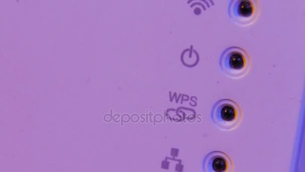 Closeup on WiFi repeater signal connection status led lights. The device is in electrical socket on the wall. It help to extend wireless network in home or office. - Footage, Video