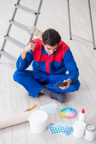 Mladý malíř se snaží sladit barvy pro malířskou práci - Fotografie, Obrázek