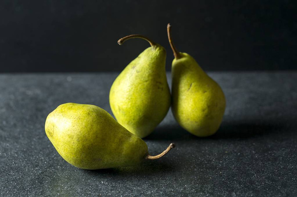 Green pears lying on dark background - Fotografie, Obrázek