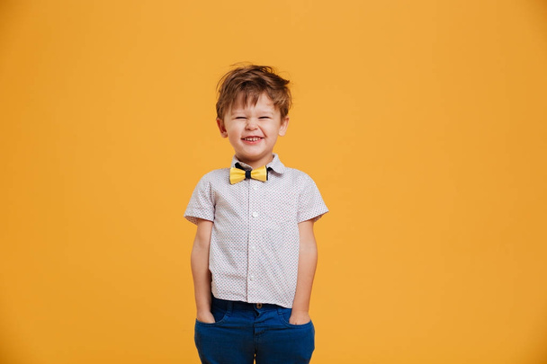 Cheerful little boy child standing isolated - Fotó, kép
