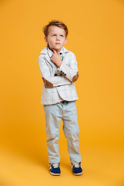 Thoughtful little boy child standing isolated - Foto, imagen