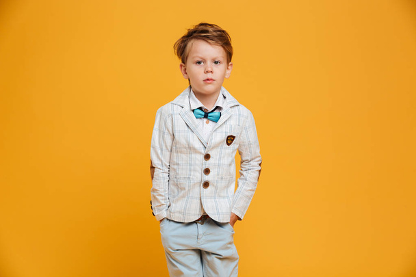 Serious little boy child standing isolated - Foto, imagen