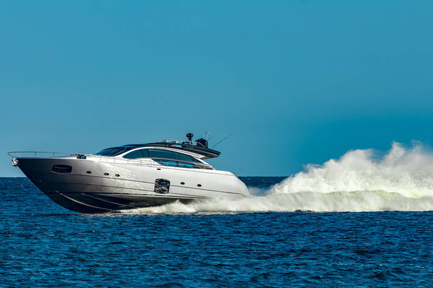Grey speedboat moving fast by the river in Latvia. Water sport - Photo, Image