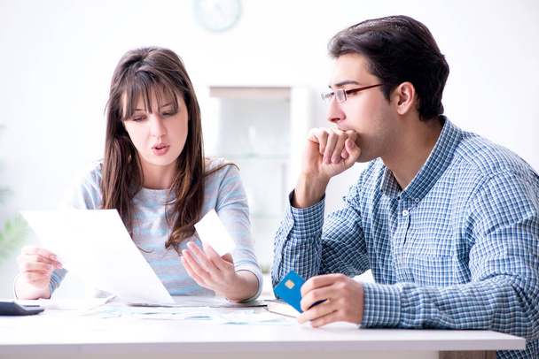 A fiatal pár a családi pénzügyi papírokat nézi - Fotó, kép