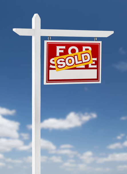 Right Facing Sold For Sale Real Estate Sign on a Blue Sky with Clouds. - Photo, Image