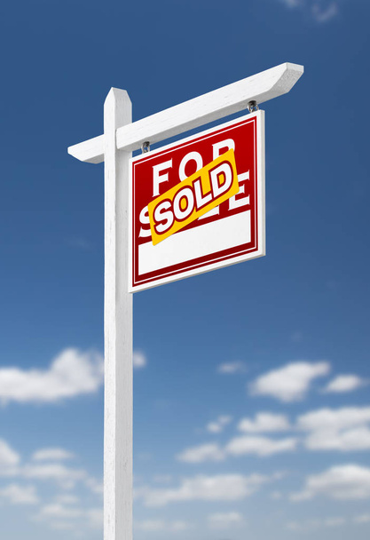 Right Facing Sold For Sale Real Estate Sign on a Blue Sky with Clouds. - Photo, Image