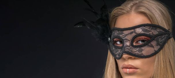 Portrait of a beautiful blond woman wearing black mask. Fashion  - Fotografie, Obrázek